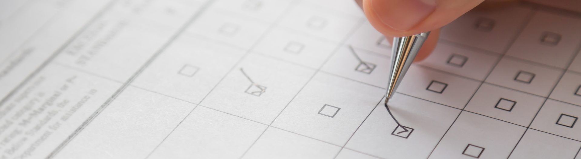 Hand with pen over application form